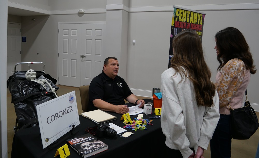 Coroner Kenny Pratt talking to student during Truth or Consequences