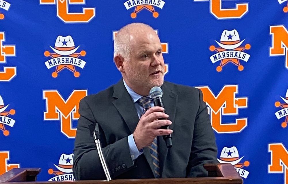 Merrick speaking at podium