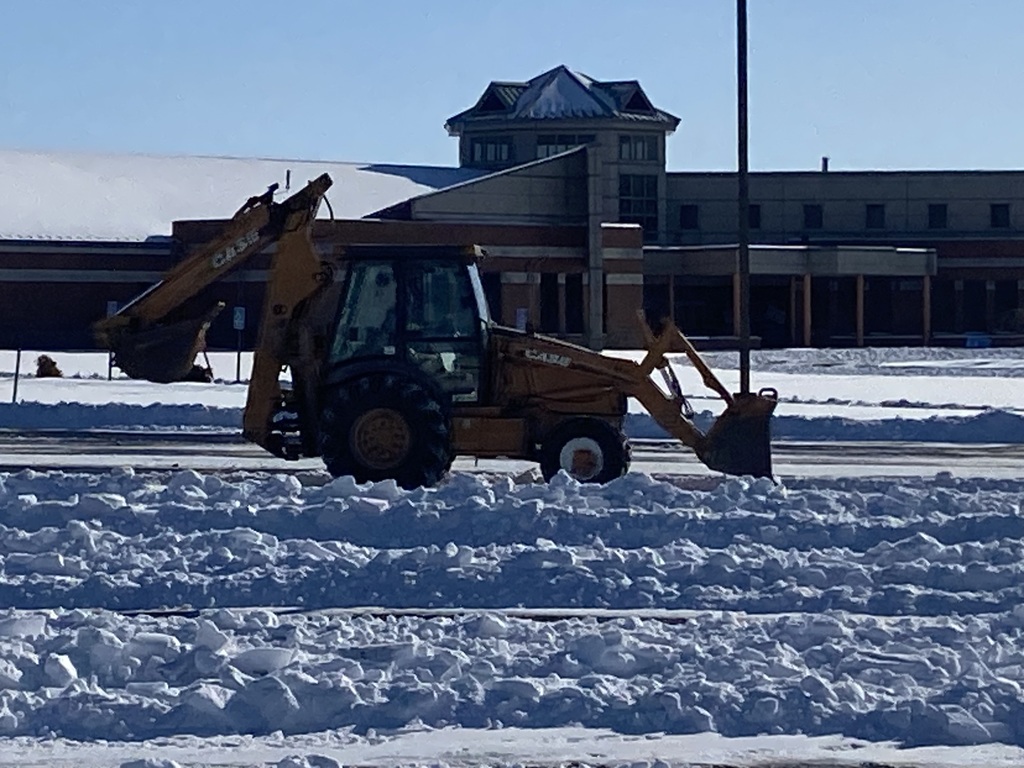 Backhoe clearing NMMS parking lot