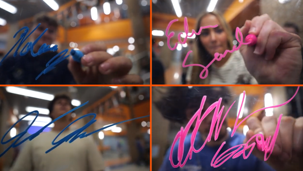 Screen grab from senior sign off video featuring MCHS seniors signing their name