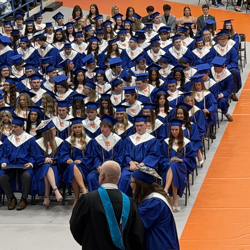 Graduate walking across stage to receive diploma