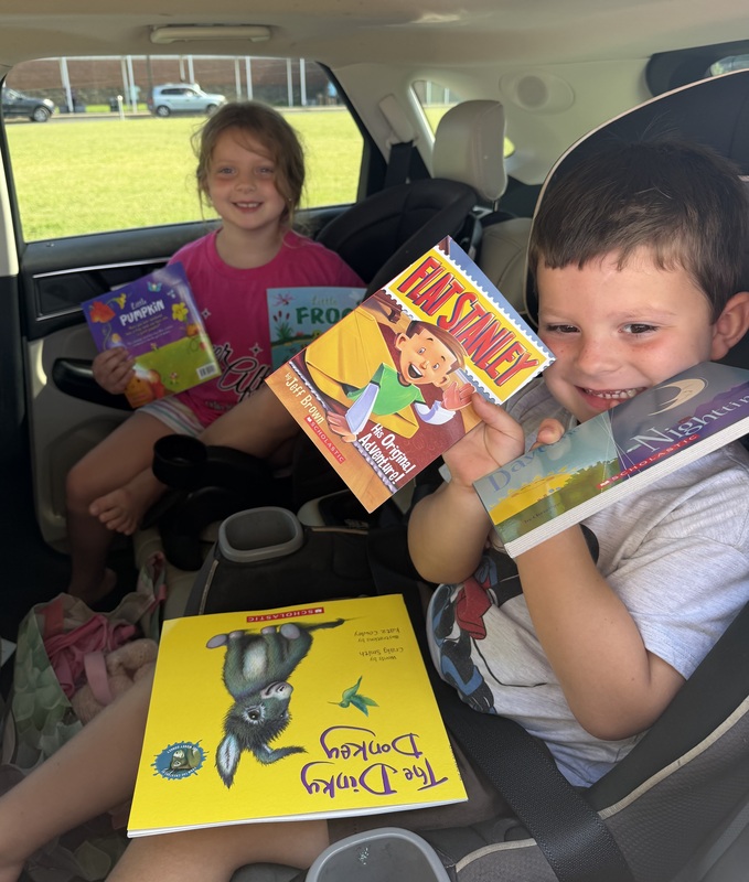 Kids with books given away through reading grant
