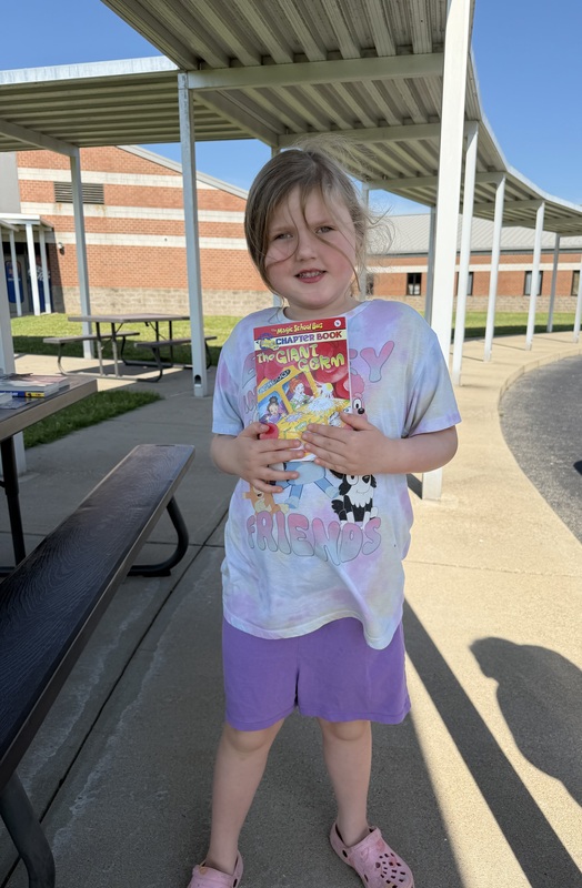 Student with book given away through reading grant