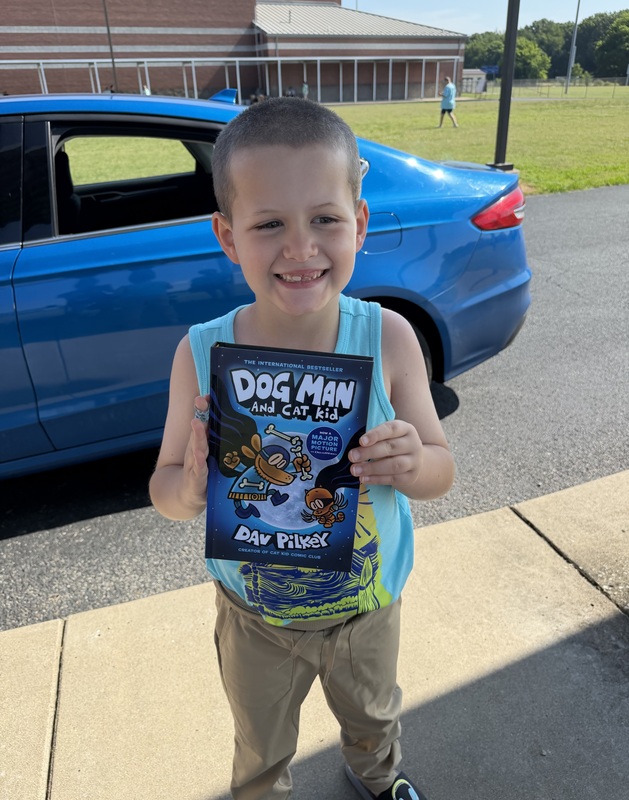 Student  with book given away through reading grant