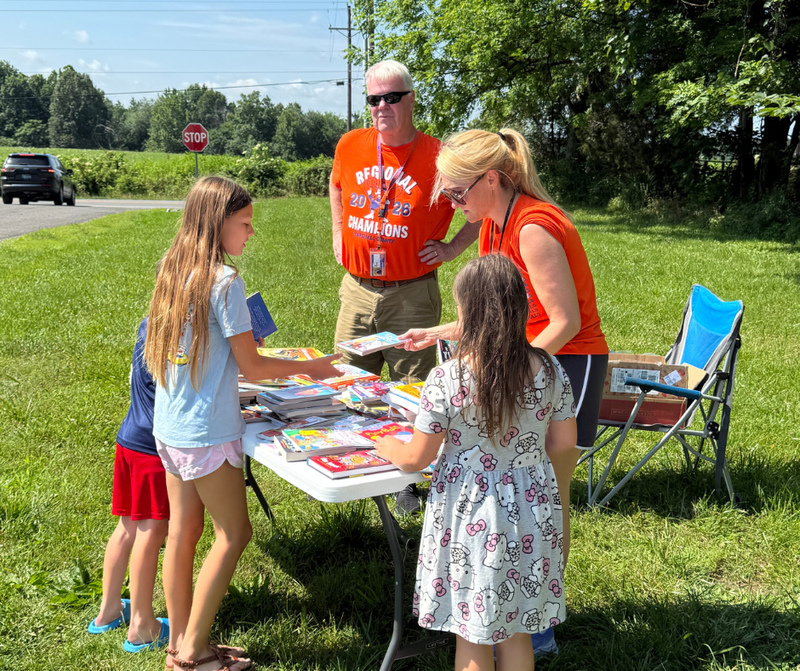 Supt. Thorpe, Grant Writer Monique Zuber and students at book giveaway at JES