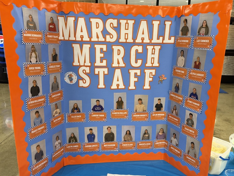 Tri fold board with names and photos of all Marshall Merch Staff