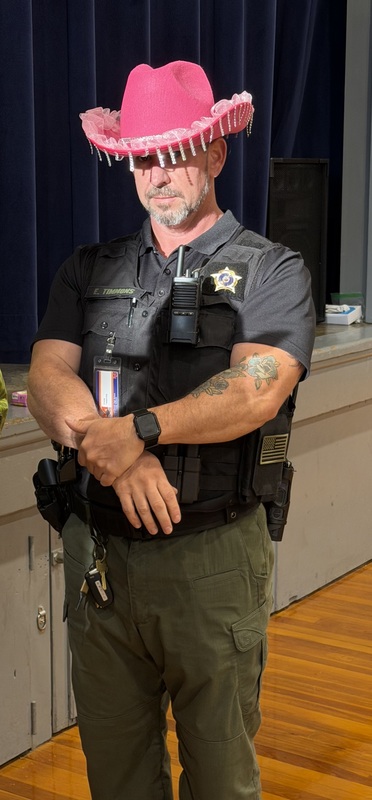 Photo of CCES stuSRO officer in gym dressed in pink cowboy hats in honor of Dolly Parton