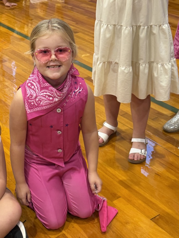 Photo of CCES student in gym dressed in pink cowboy hats in honor of Dolly Parton