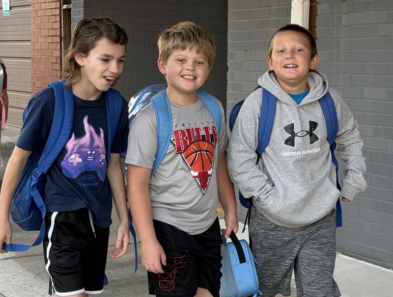 Three BES students pose while walking to school on International Walk to School Day
