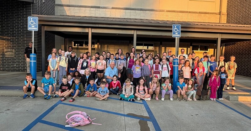 Group photo of BES students, staff and parents outside MC public library before walking to the school on International Walk to School Day