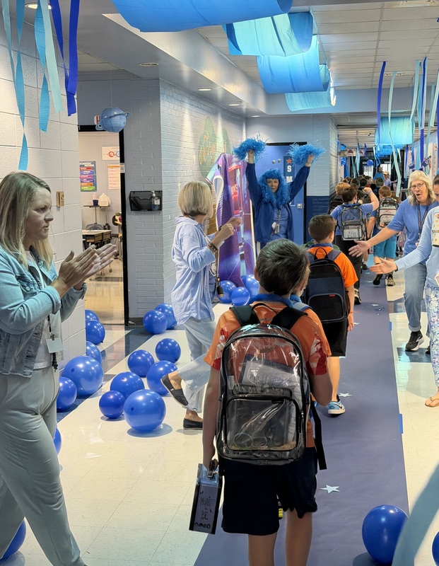 SMES students entering school decorated in blue