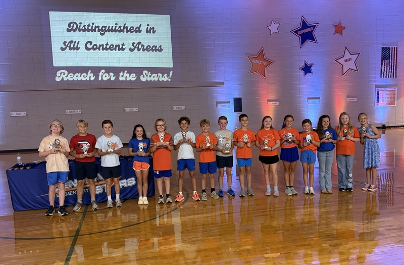 CES students lined up in gym being recognized for scoring distinguished in all content areas