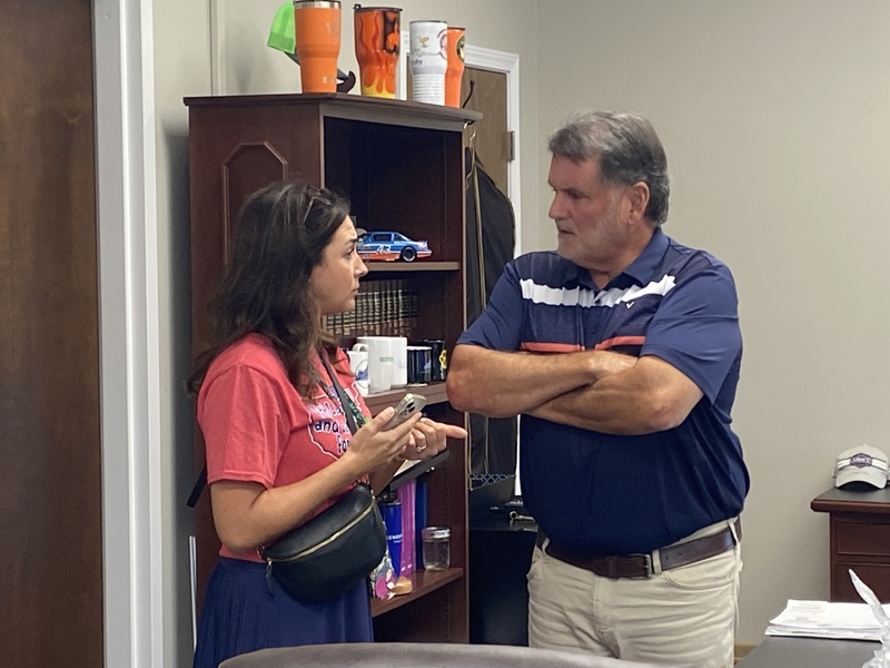 Judge Ex. Spraggs talks with teacherin his office