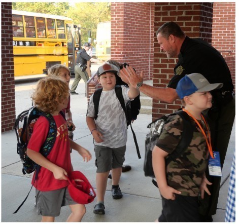 JES students greeted at school with high fives/fist bumps