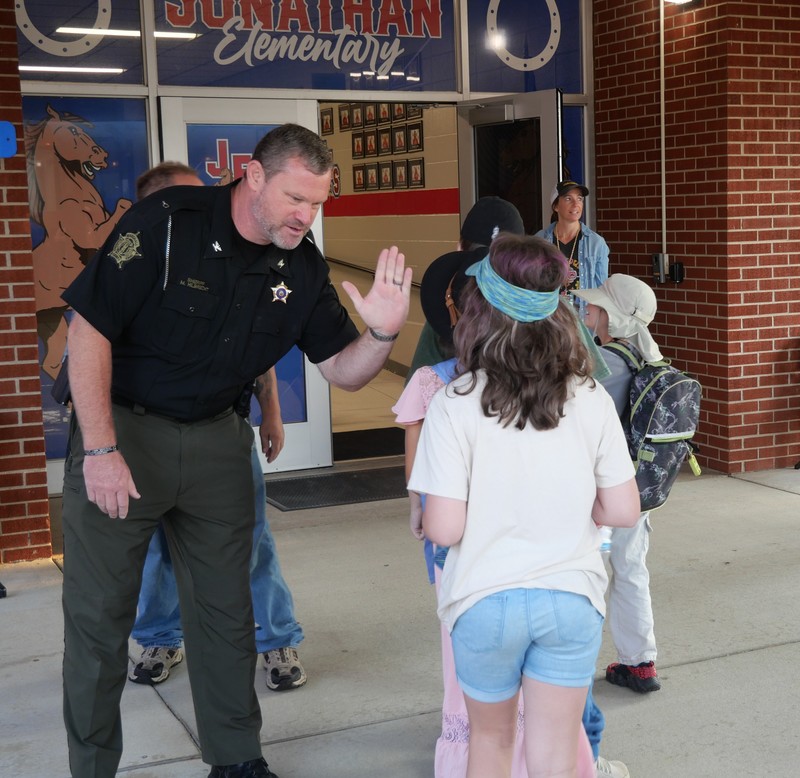 JES students greeted at school with high fives/fist bumps