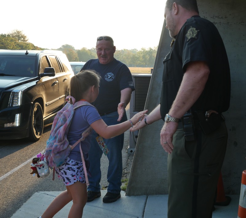 JES students greeted at school with high fives/fist bumps
