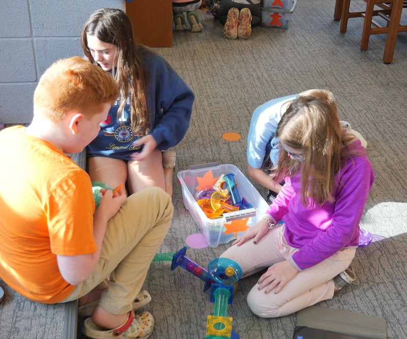 SES student working with Picasso Tiles