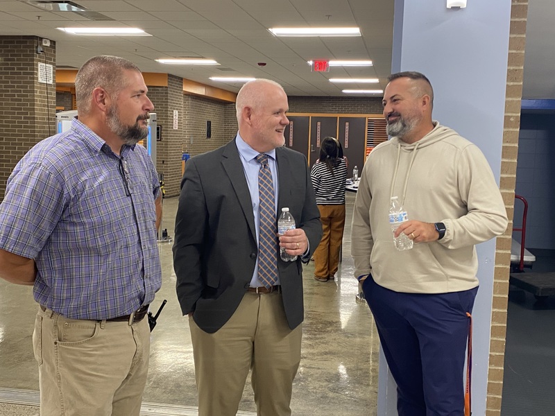 Merrick talking with staff