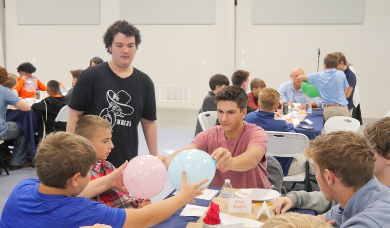 Marshall Male Conference attendees work on balloon project