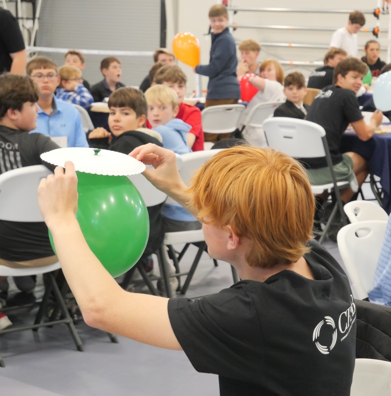Marshall Male Conference attendees work on balloon project