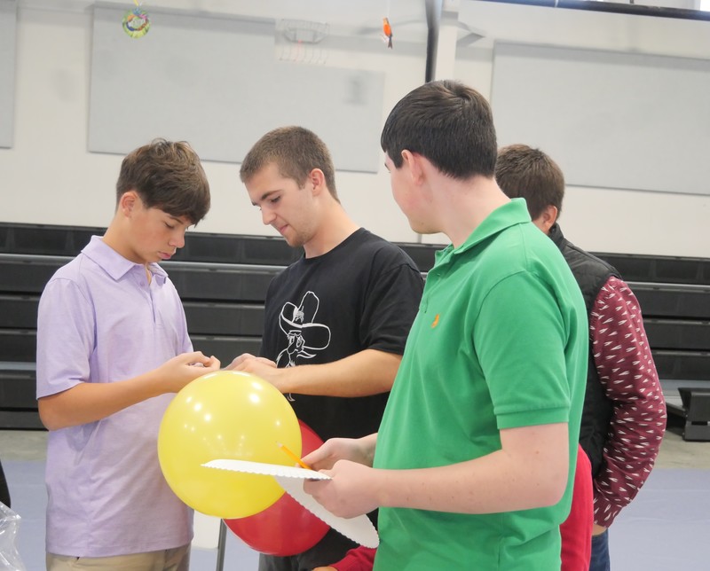 Marshall Male Conference attendees work on balloon project