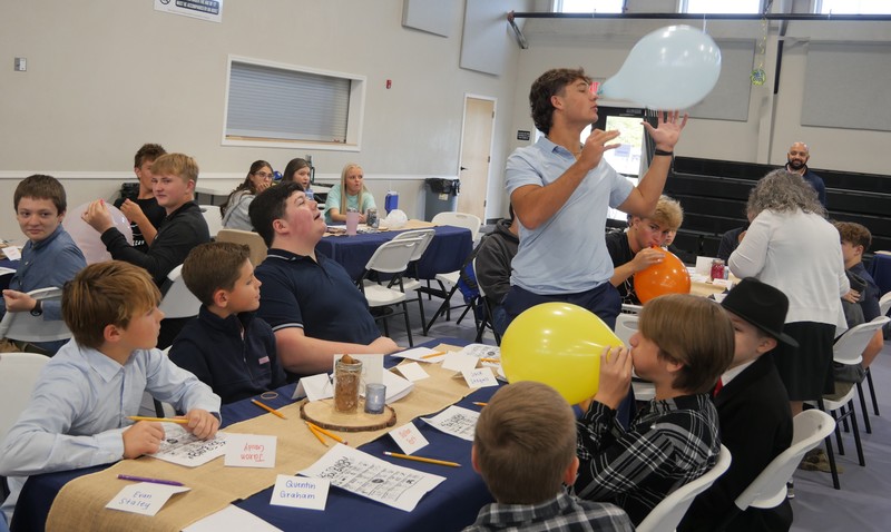 Marshall Male Conference attendees work on balloon project