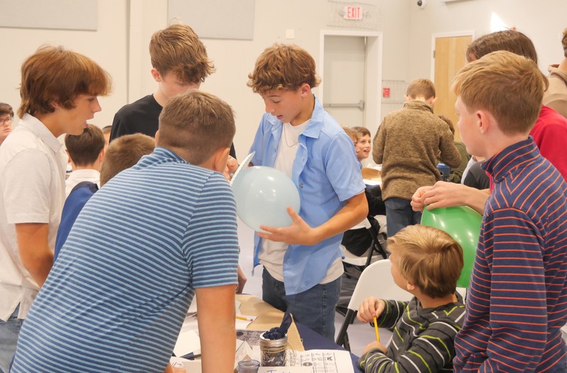 Marshall Male Conference attendees work on balloon project