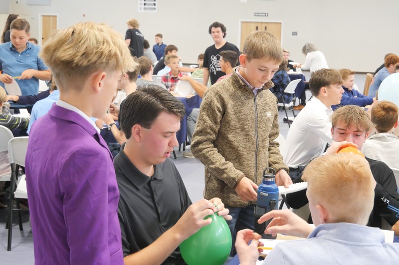 Marshall Male Conference attendees work on balloon project