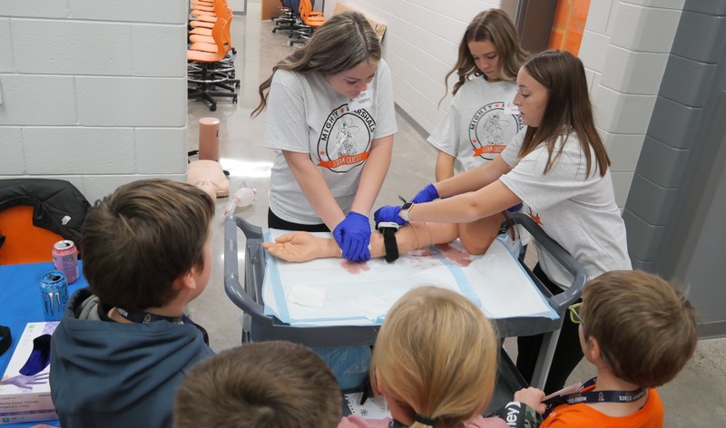 Students observe use of tourniquet