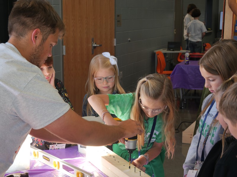 Students use drill at STEAM Quest