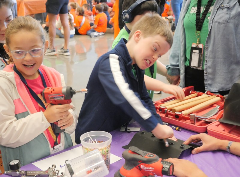 Student screws in bolt