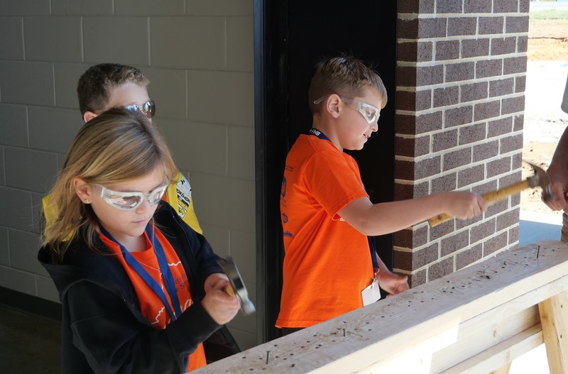 Students hammer nails at STEAM Quest