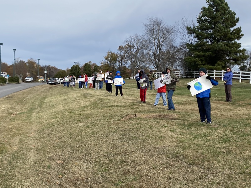 SES Students Line Road with Signs