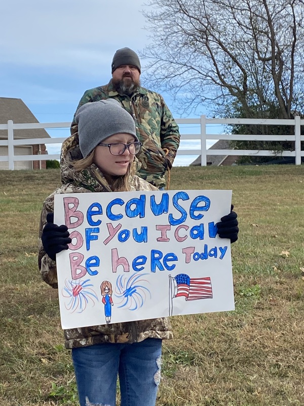 SES Students Line Road with Signs