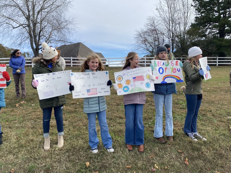 SES Students Line Road with Signs