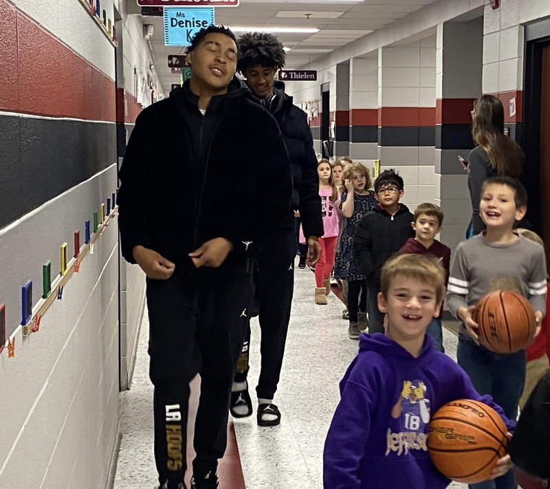 Link students walk in hall with BES students