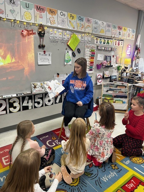 High School students reading to Elementary students
