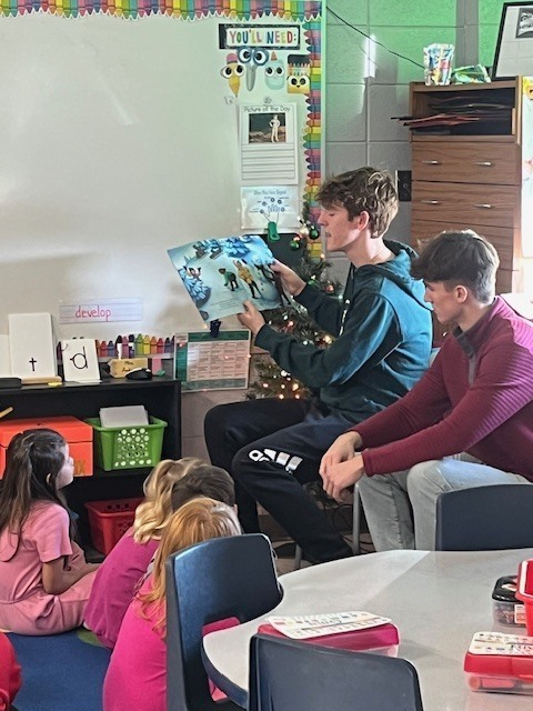 High School students reading to Elementary students