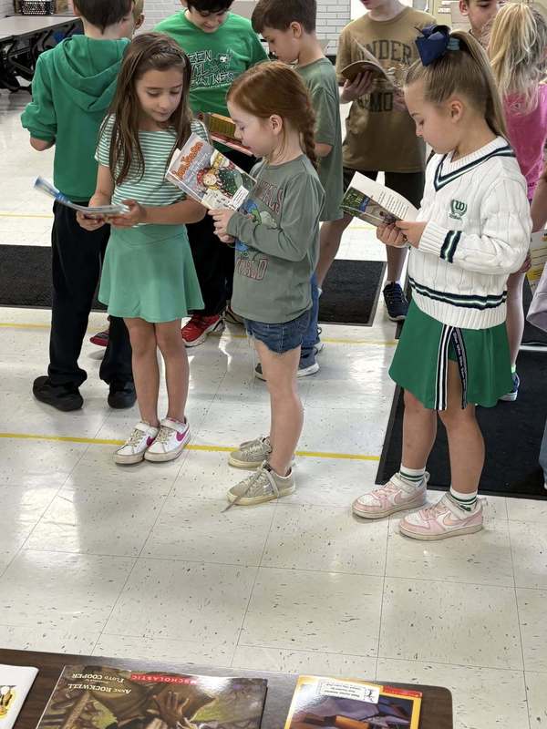 MC Students with books donated by MC Rotary