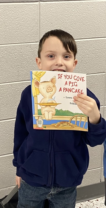 MC Students with books donated by MC Rotary