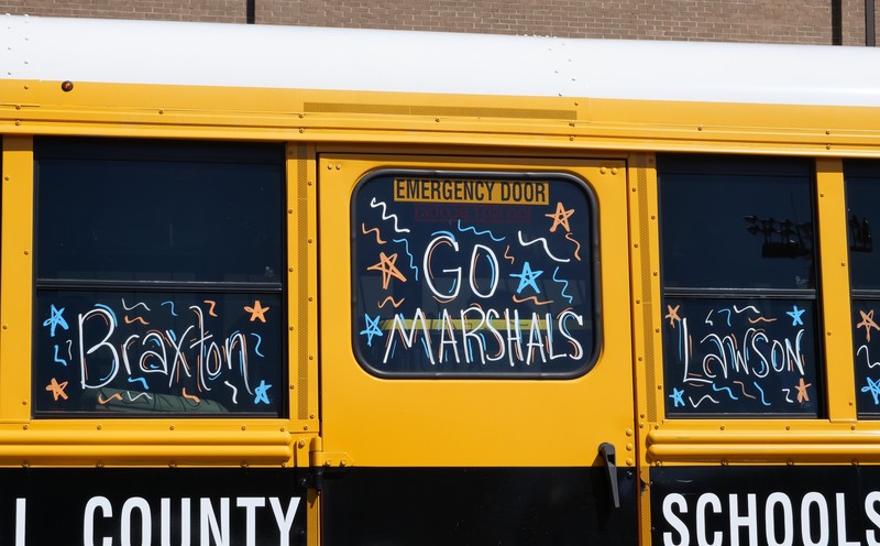 School bus decorated with  player names and Go Marshals