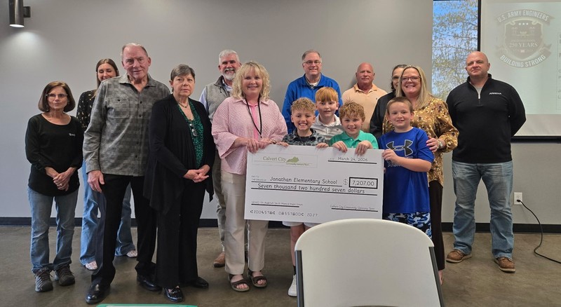 JES teacher and students holding cardboard check  from grant received from Calvert City Community Advisory Team