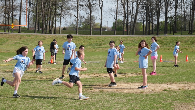 Students playing running game at Team Ultra Field Day