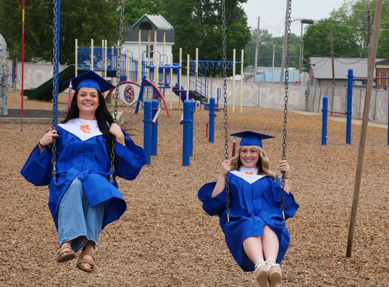 Two seniors swinging at the BES playground