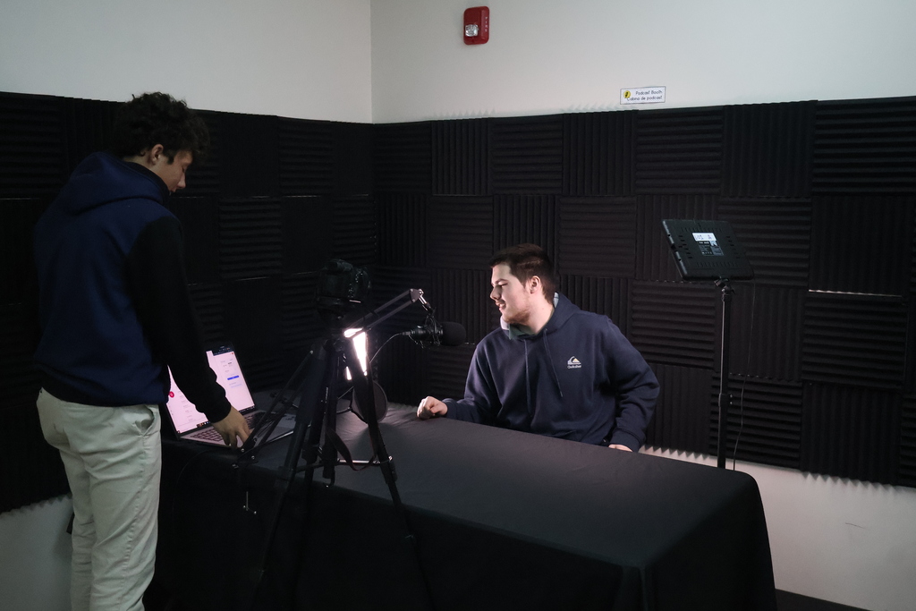 Two students working together to record an interview in Multimedia