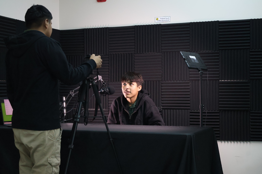 Two students working together to record an interview in Multimedia