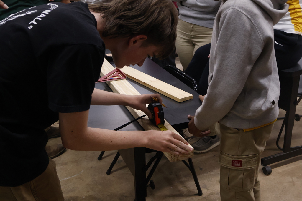 Student using a tape measure