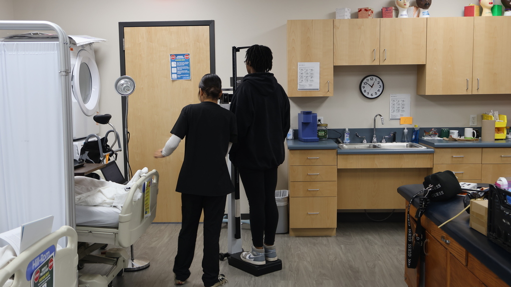 Student conducting a height screener