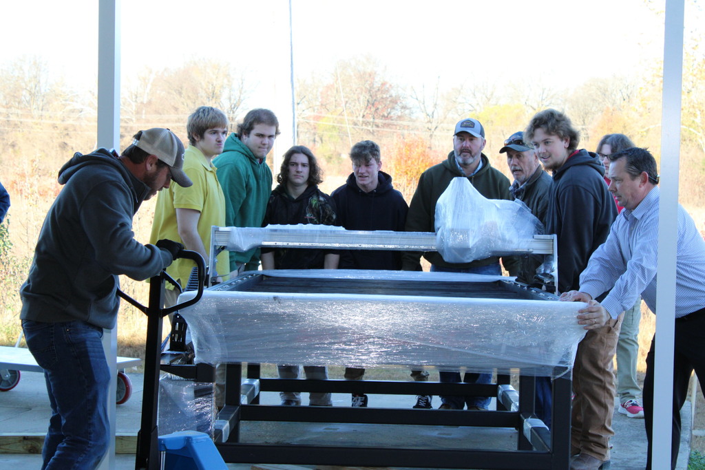 Industrial Maintenance students help unload the CNC Plasma Cutter Table. 