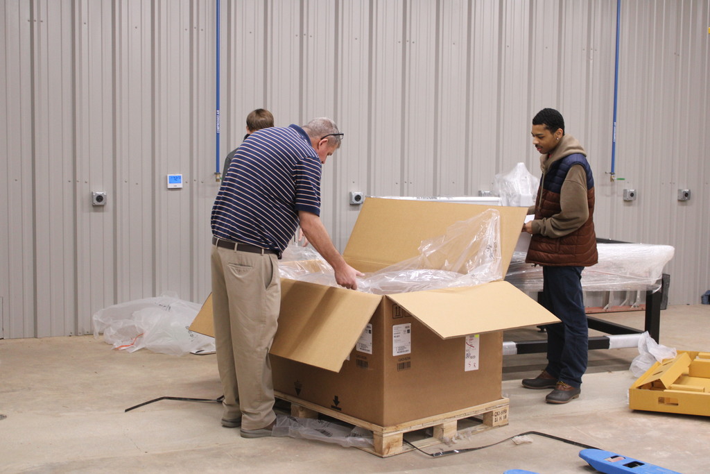 Students unboxing plasma table